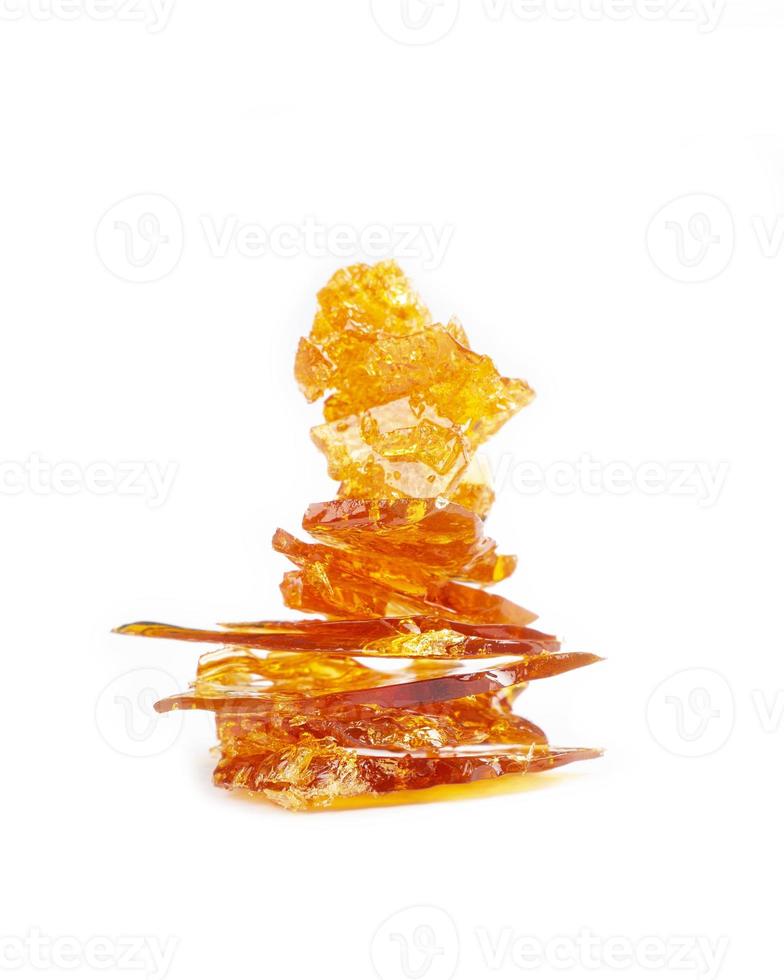 a pieces of cannabis wax closeup. concentrate dab stone with high thc isolated photo