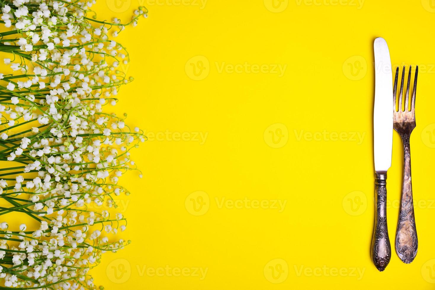 Iron vintage cutlery on a yellow background photo