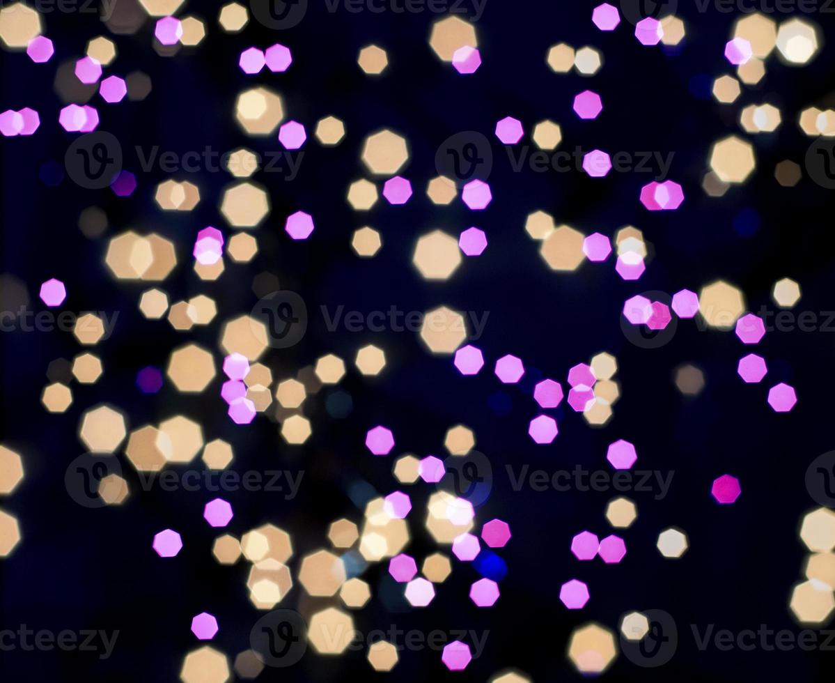 multicolored bokeh polygon on black background photo