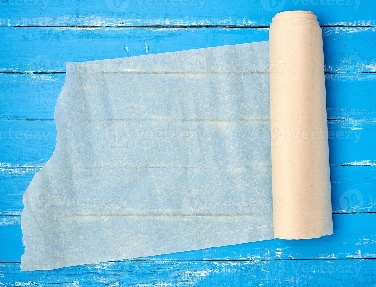 unfolded scroll of light beige parchment paper photo