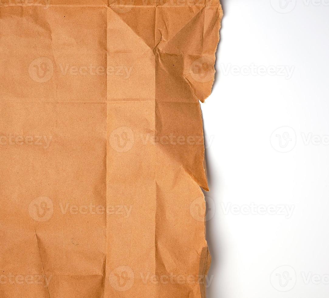 torn piece of brown craft paper with torn edges photo