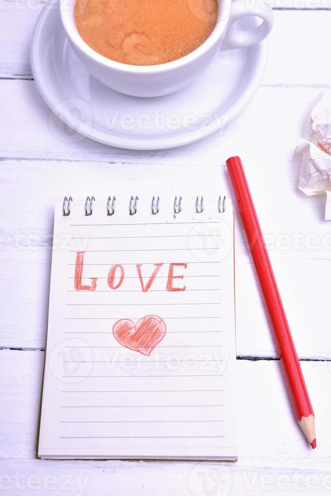 Notebook and red pencil photo
