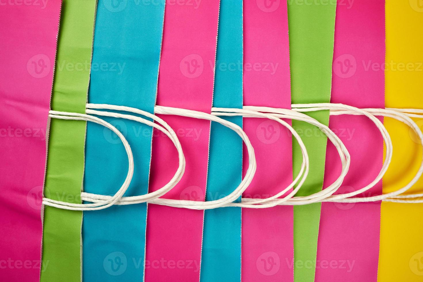 multicolored paper shopping bags with handles photo