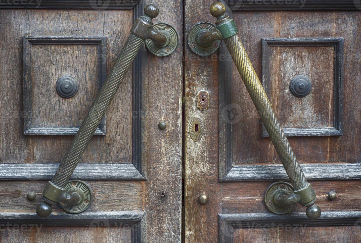 fragment of old brown door with handle and lock photo