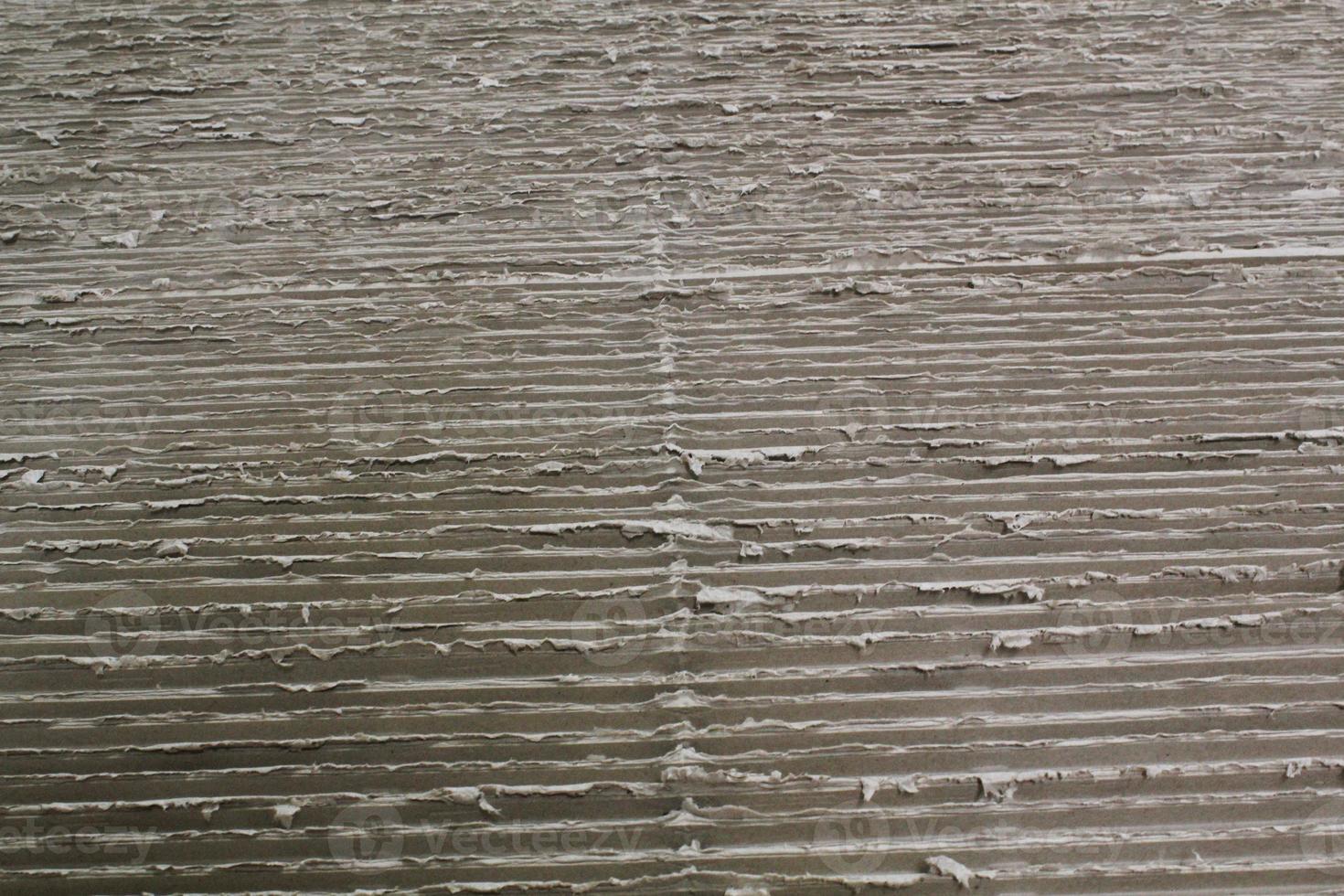 Paper grey recycled cardboard background. Natural corrugated carton sheet. Craft cardboard texture with horizontal stripe lines. Backdrop nature ecology pattern. photo