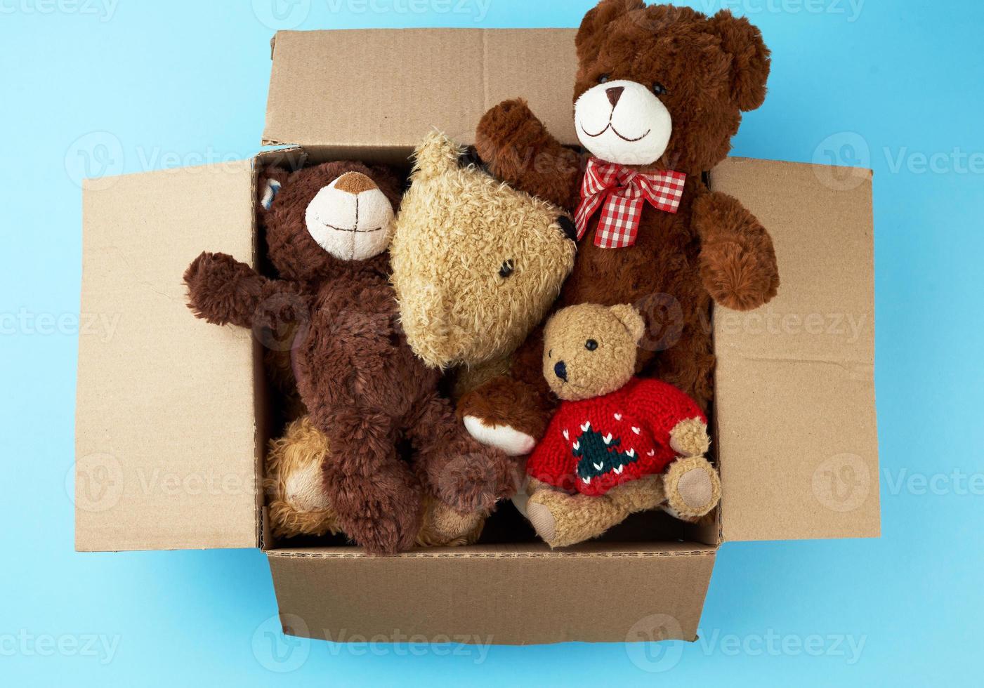 brown cardboard box with various teddy bears photo