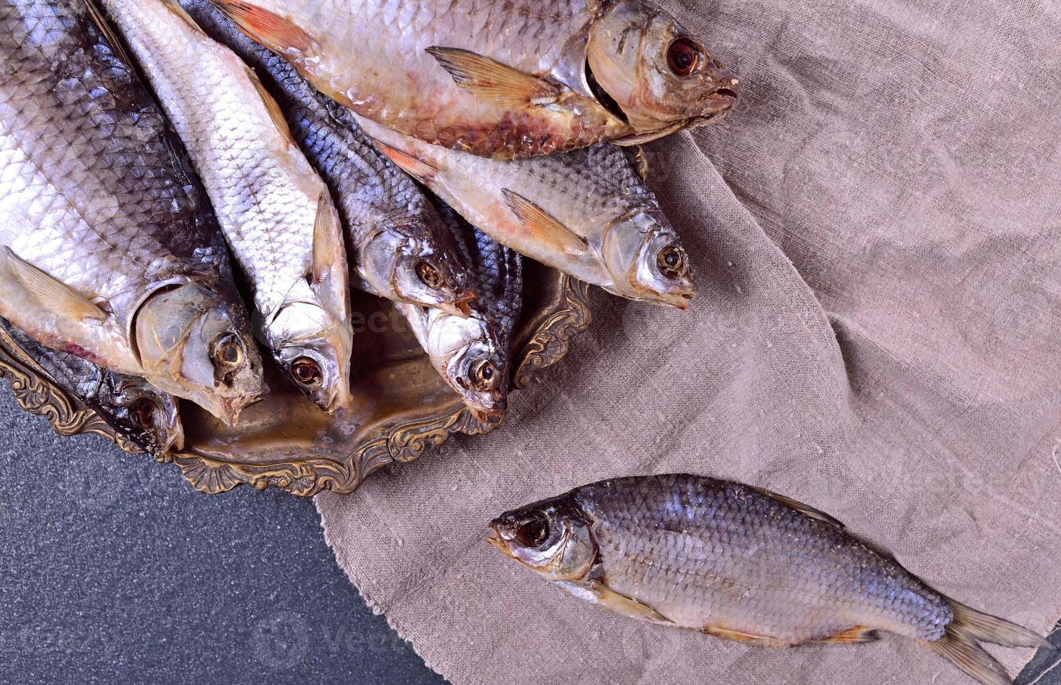 Cured fish carp on an iron plate photo