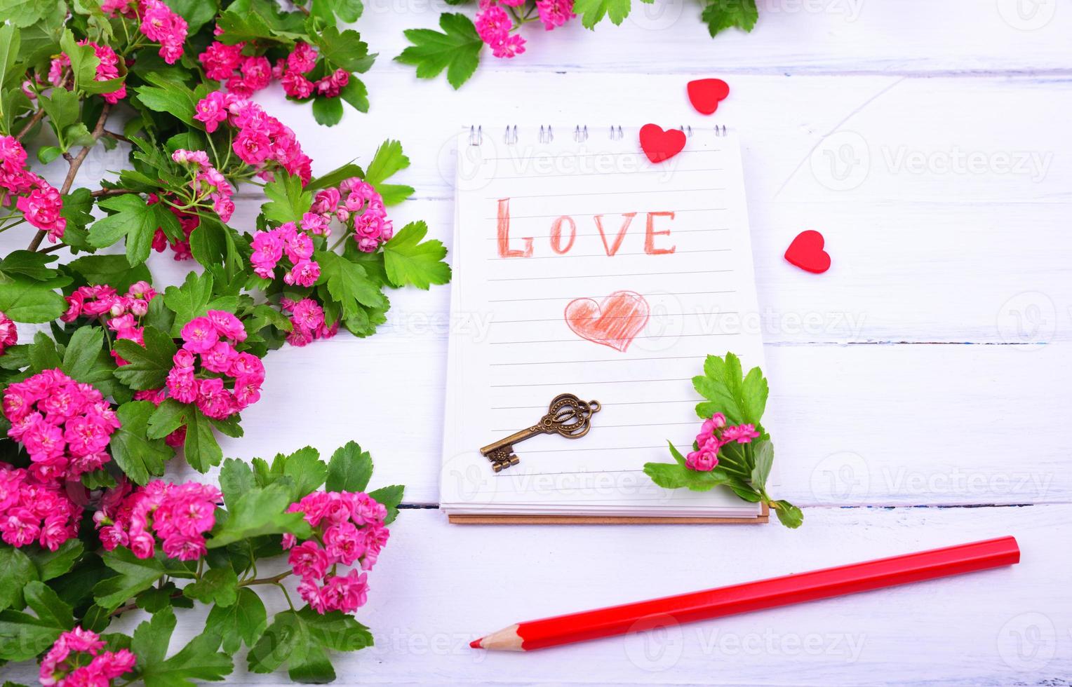 Open paper notebook with the inscription love photo
