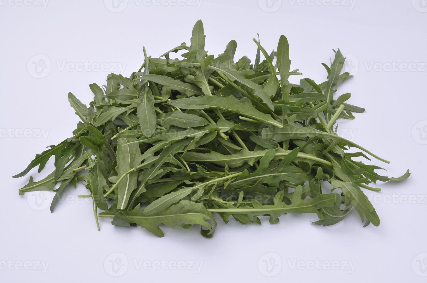 Arugula on a white plate, healthy salad photo