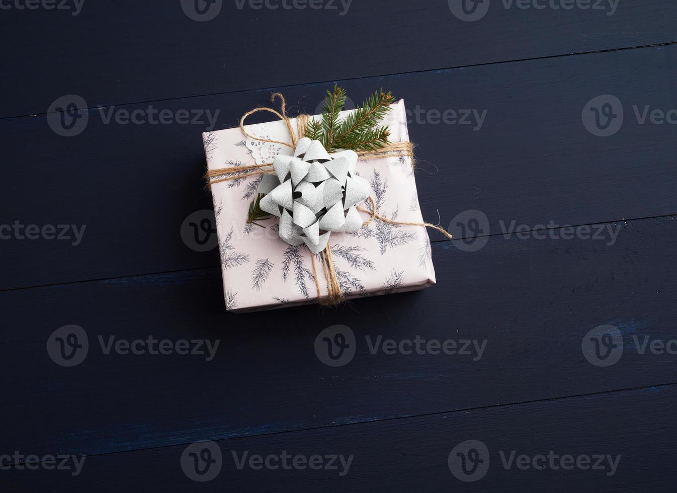 gift wrapped in colored paper on a blue wooden background photo