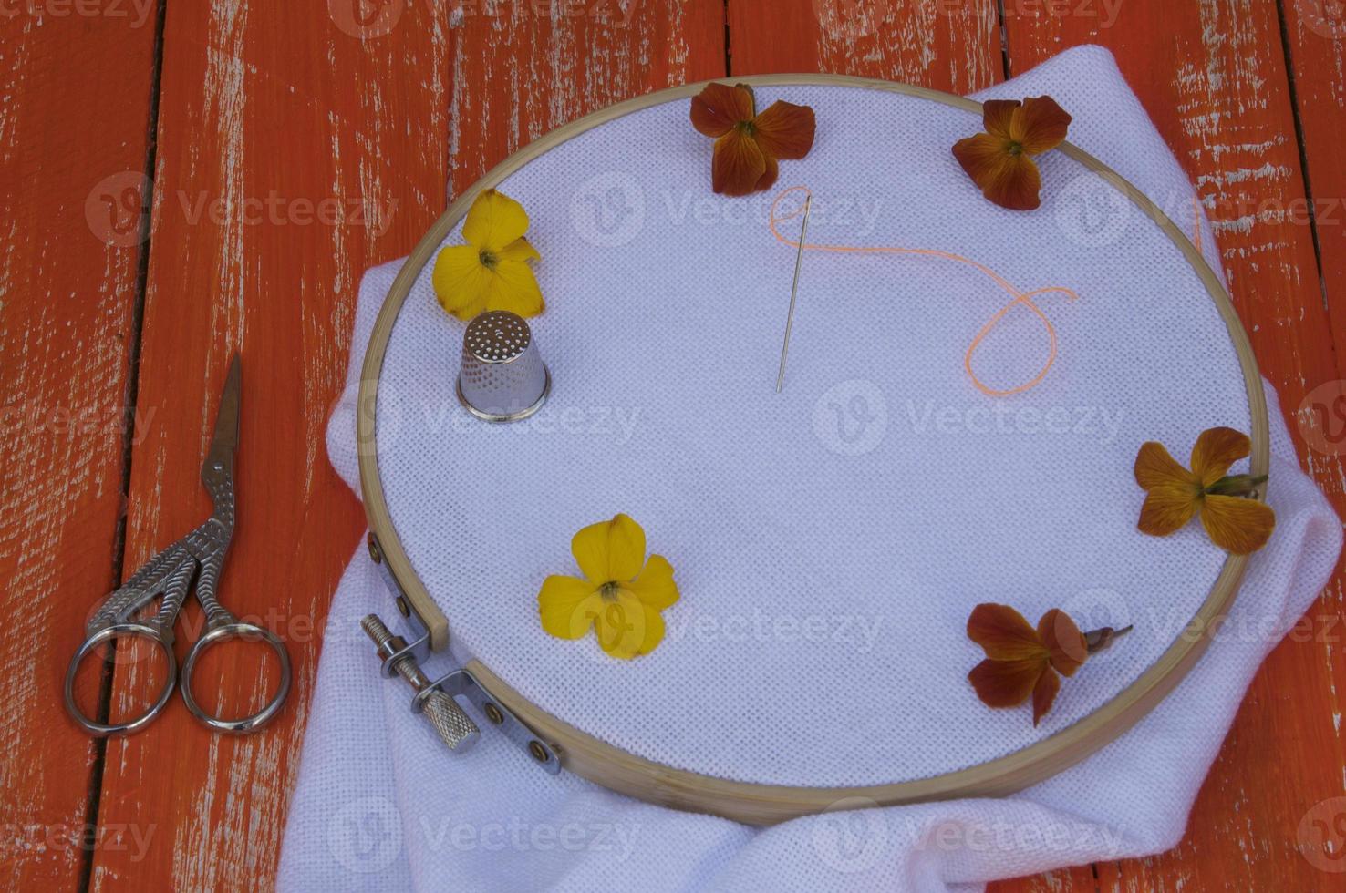 White fabric in the wooden embroidery hoop photo