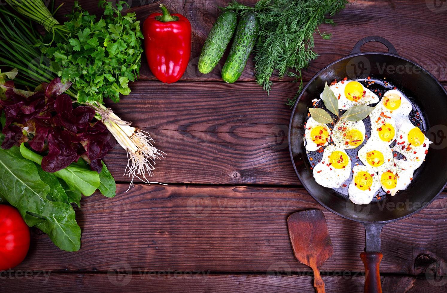 Fried quail eggs in a black castiron frying pan 18961295 Stock Photo