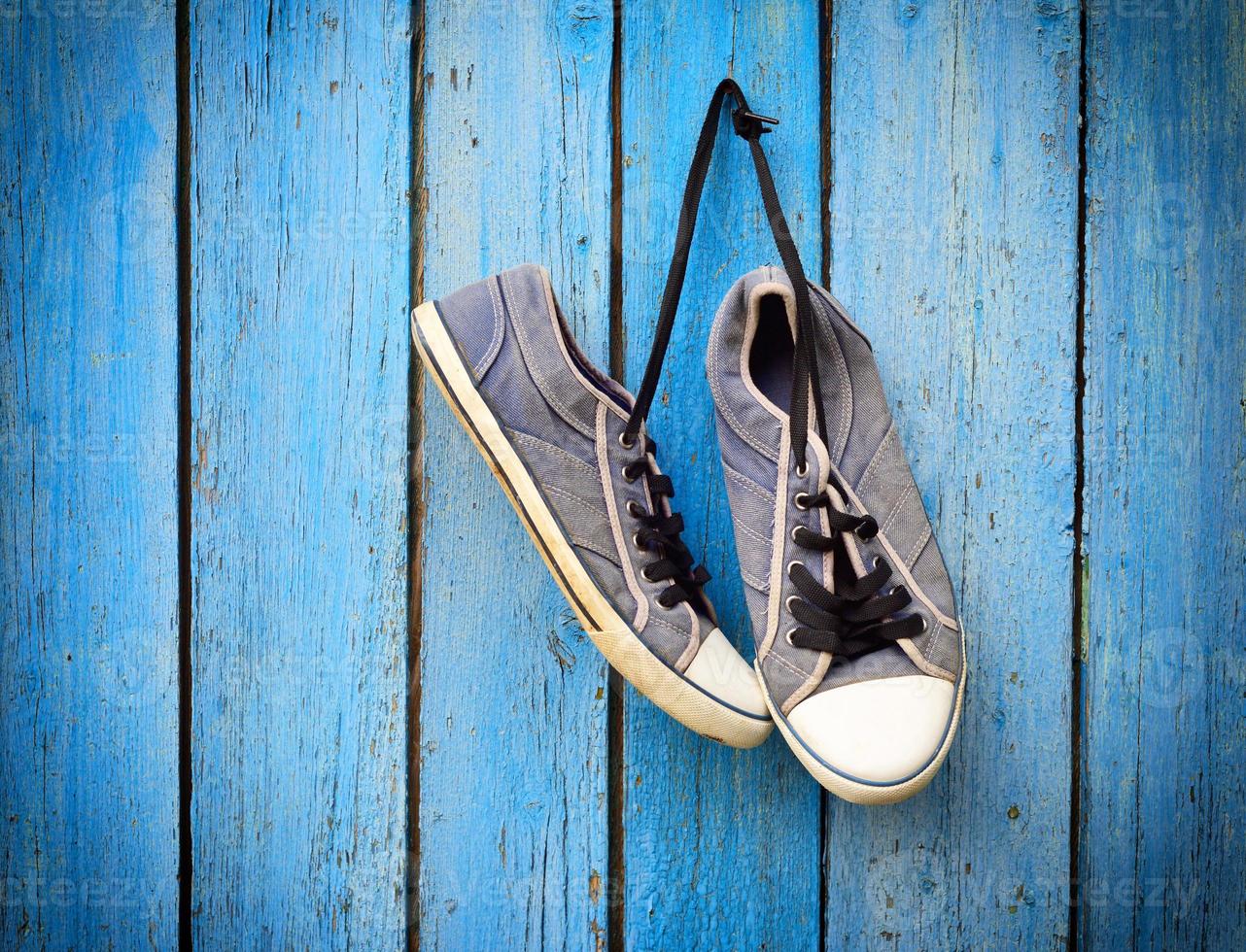 old men's shabby textile sneakers hang photo