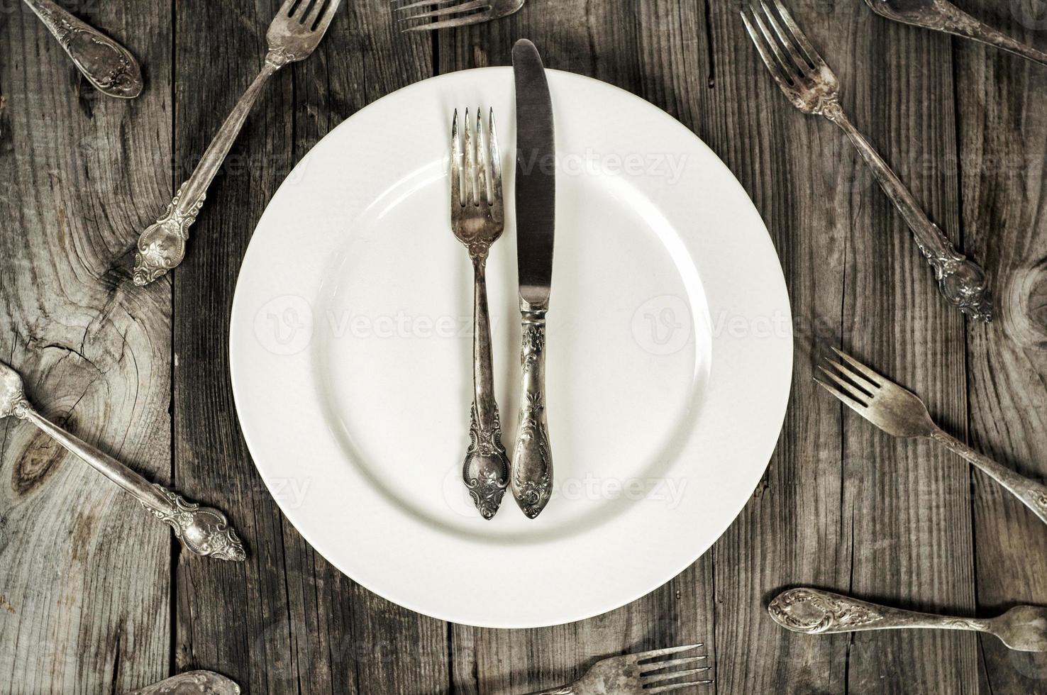 White empty plate on a gray wooden surface photo