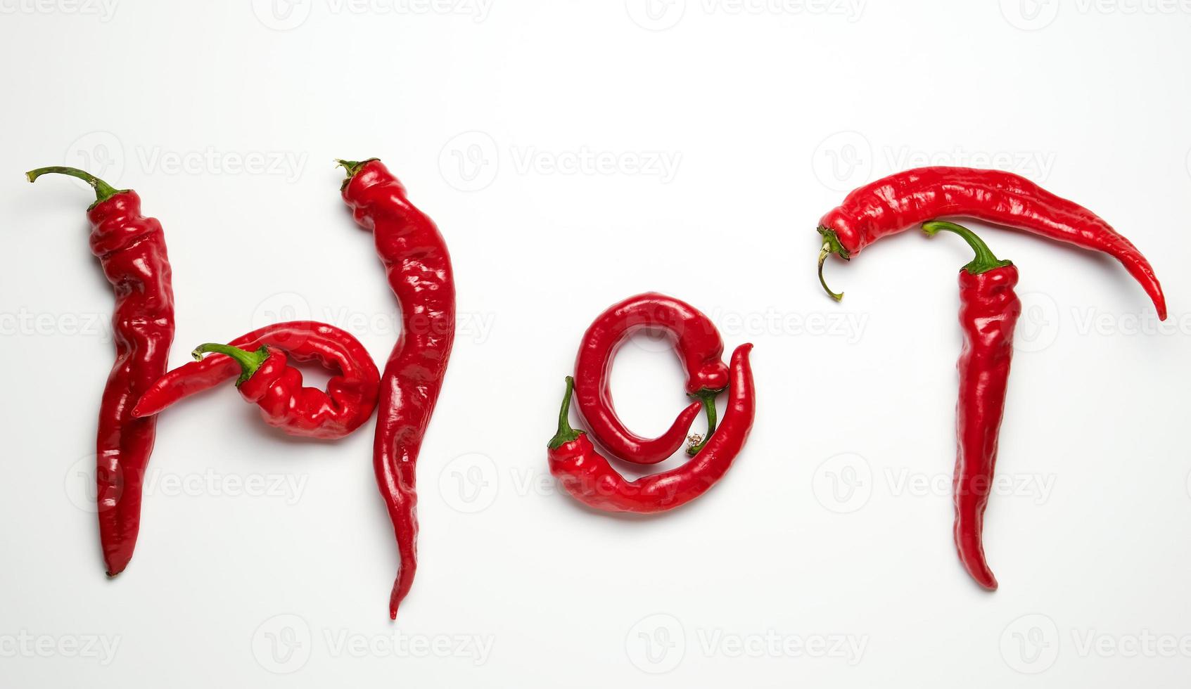 whole ripe red hot peppers on a white background photo