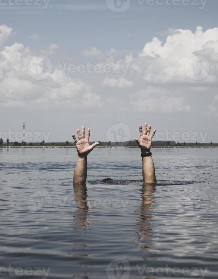 two male hands stick out of the water photo