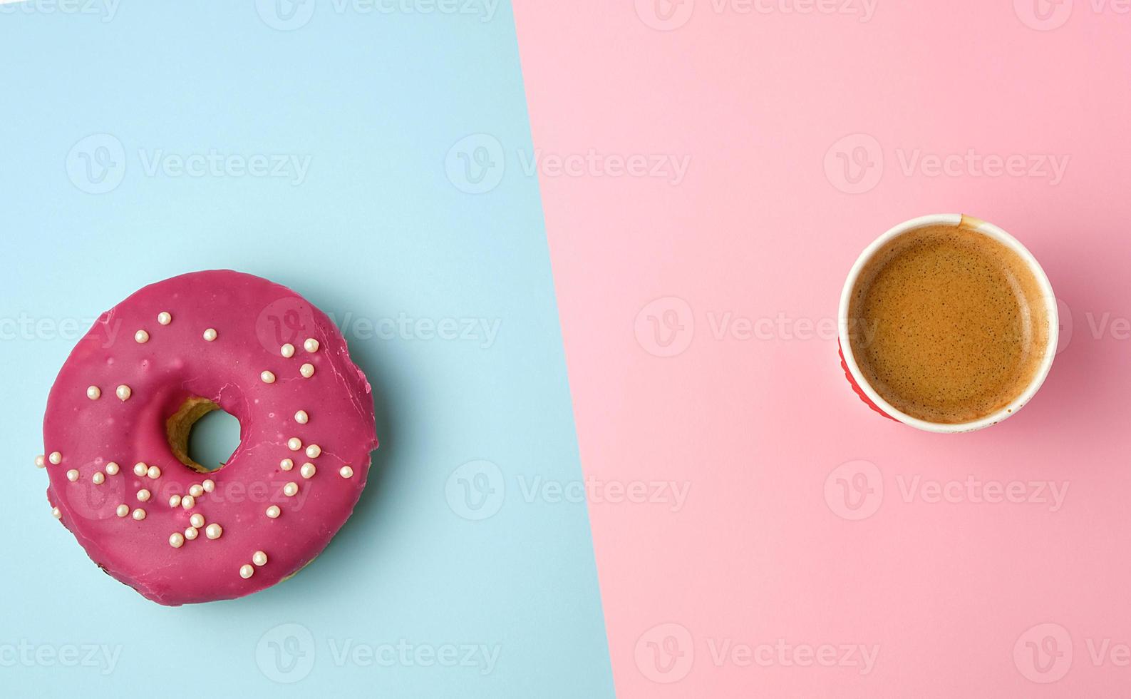 round red glazed donut and paper cup with coffee photo