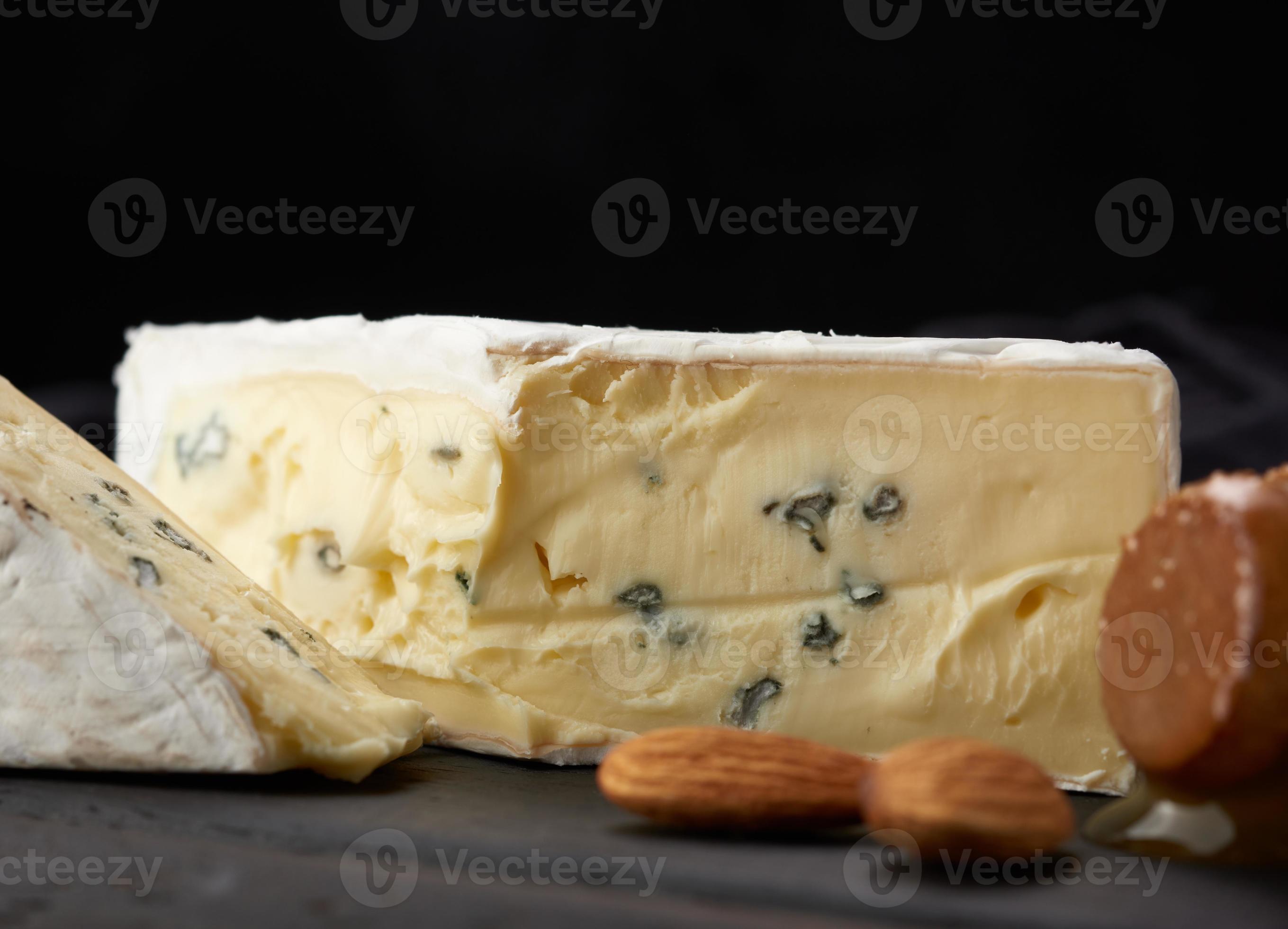 bergader blue cheese on a brown wooden board, delicious snack 18961505