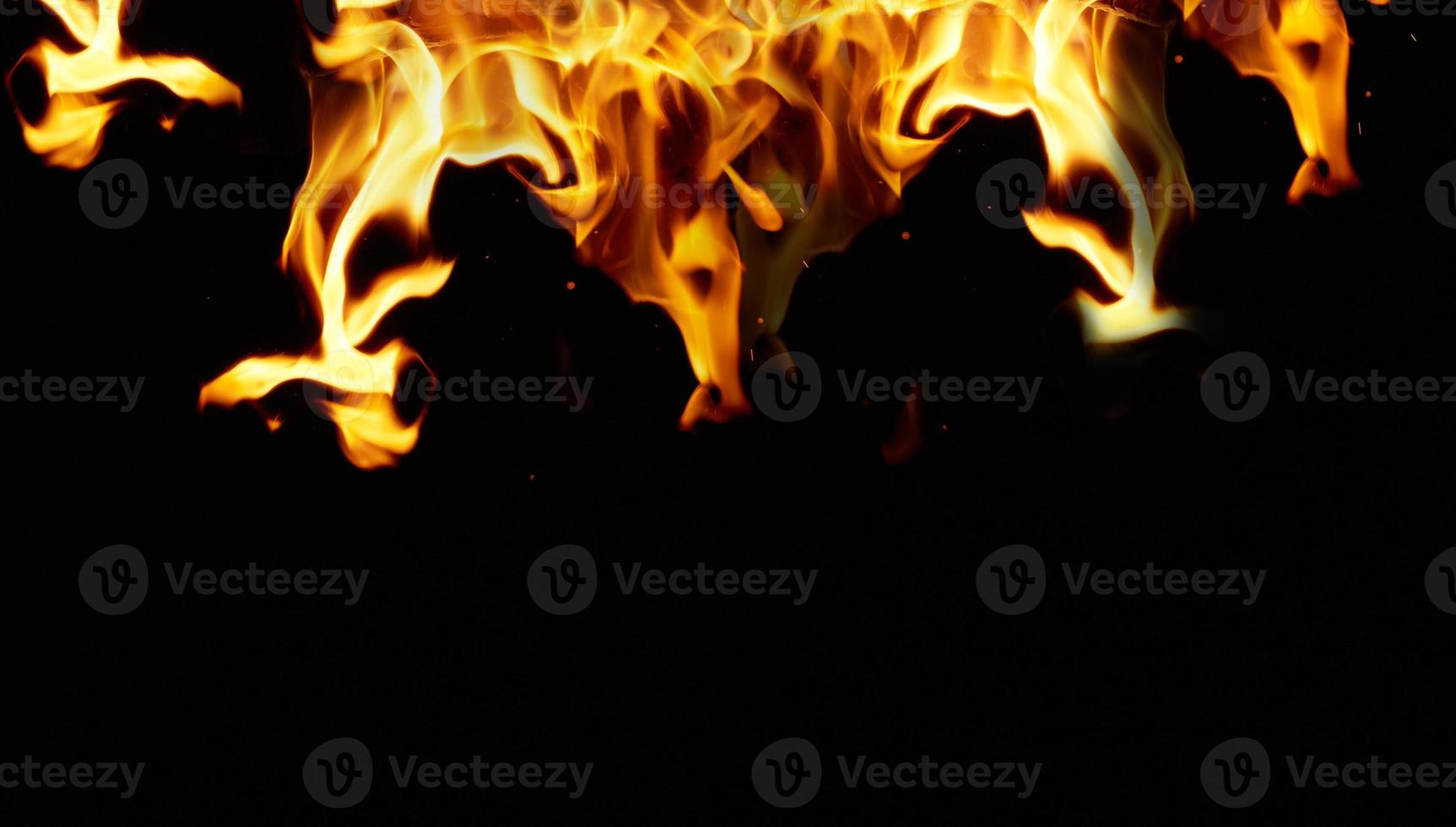 large orange flame on a black background photo