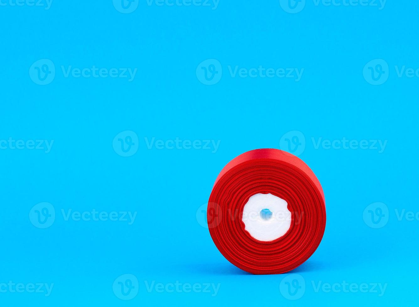 twisted bobbin of red textile silk ribbon for gift wrapping photo