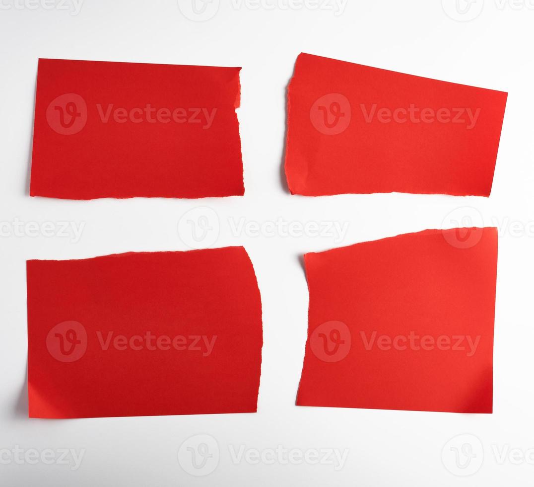various blank pieces of red paper on white background photo