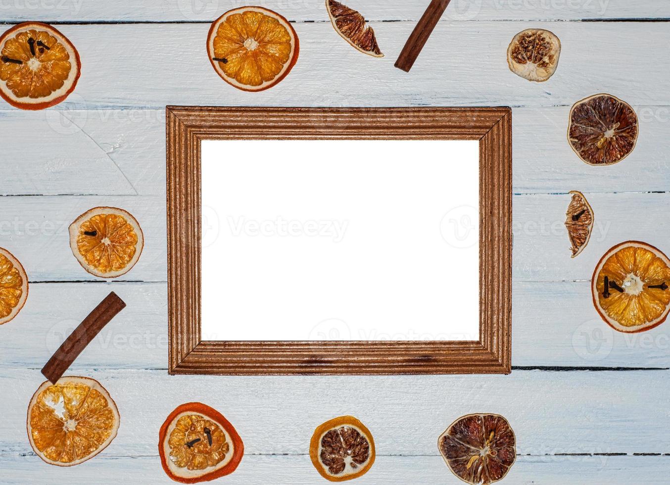 Empty wooden photo frame on white wooden surface