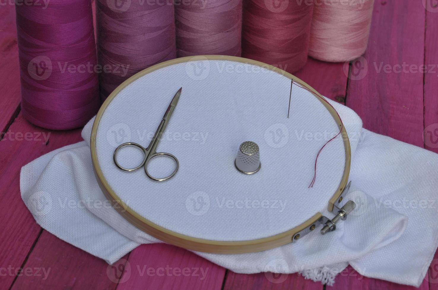 Wooden hoop with the fabric for sewing and embroidery photo