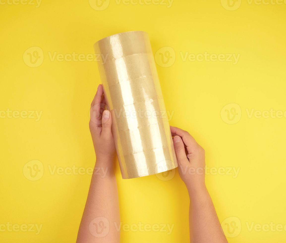 two female hands holding a stack of transparent scotch photo