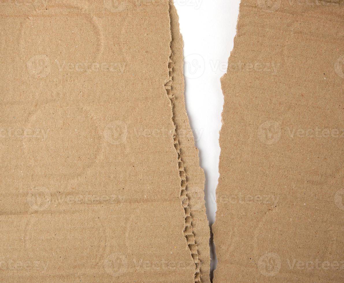 torn in half brown sheet of paper from under the box photo