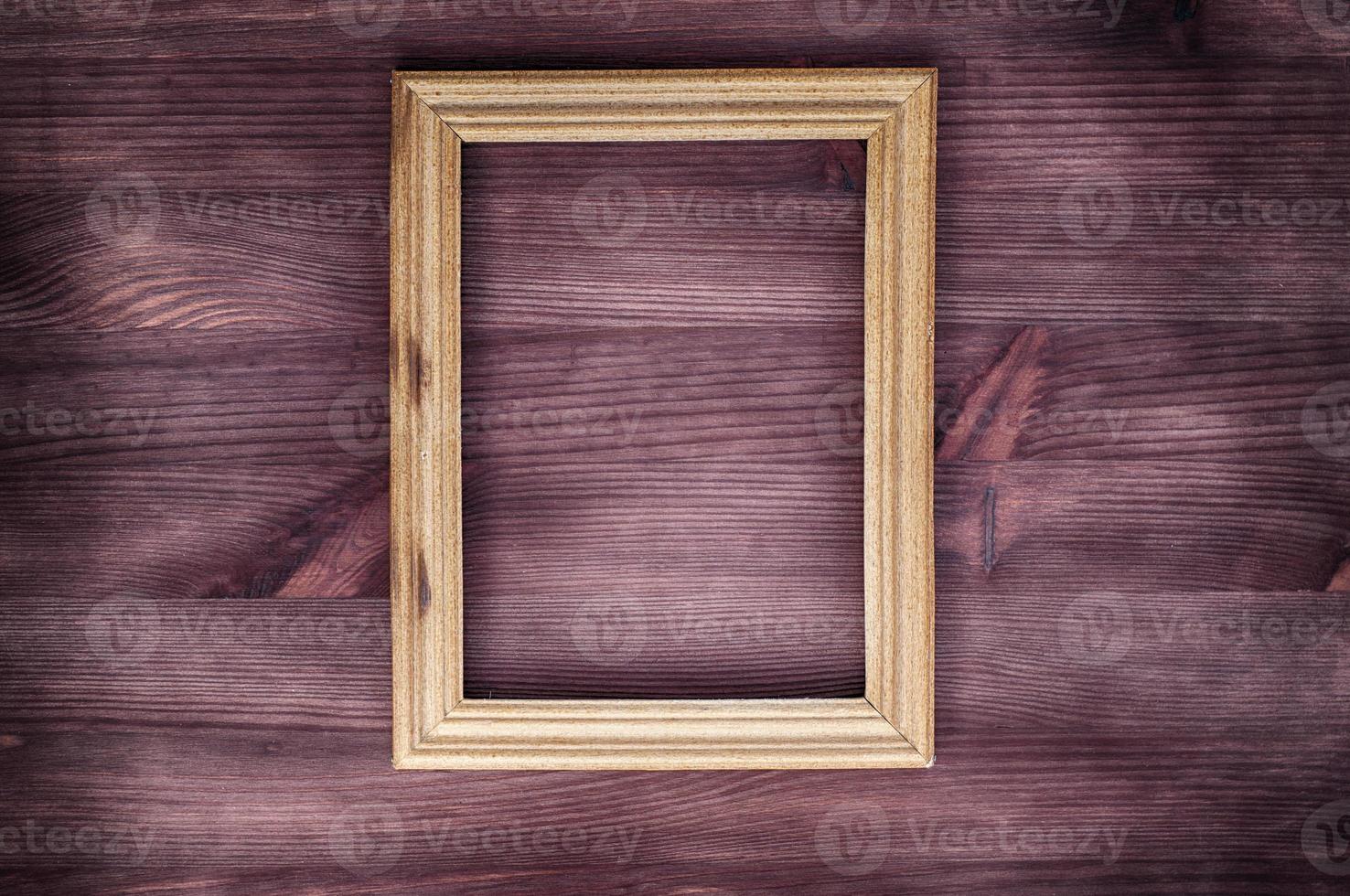 Empty wooden frame on a wood textured surface photo