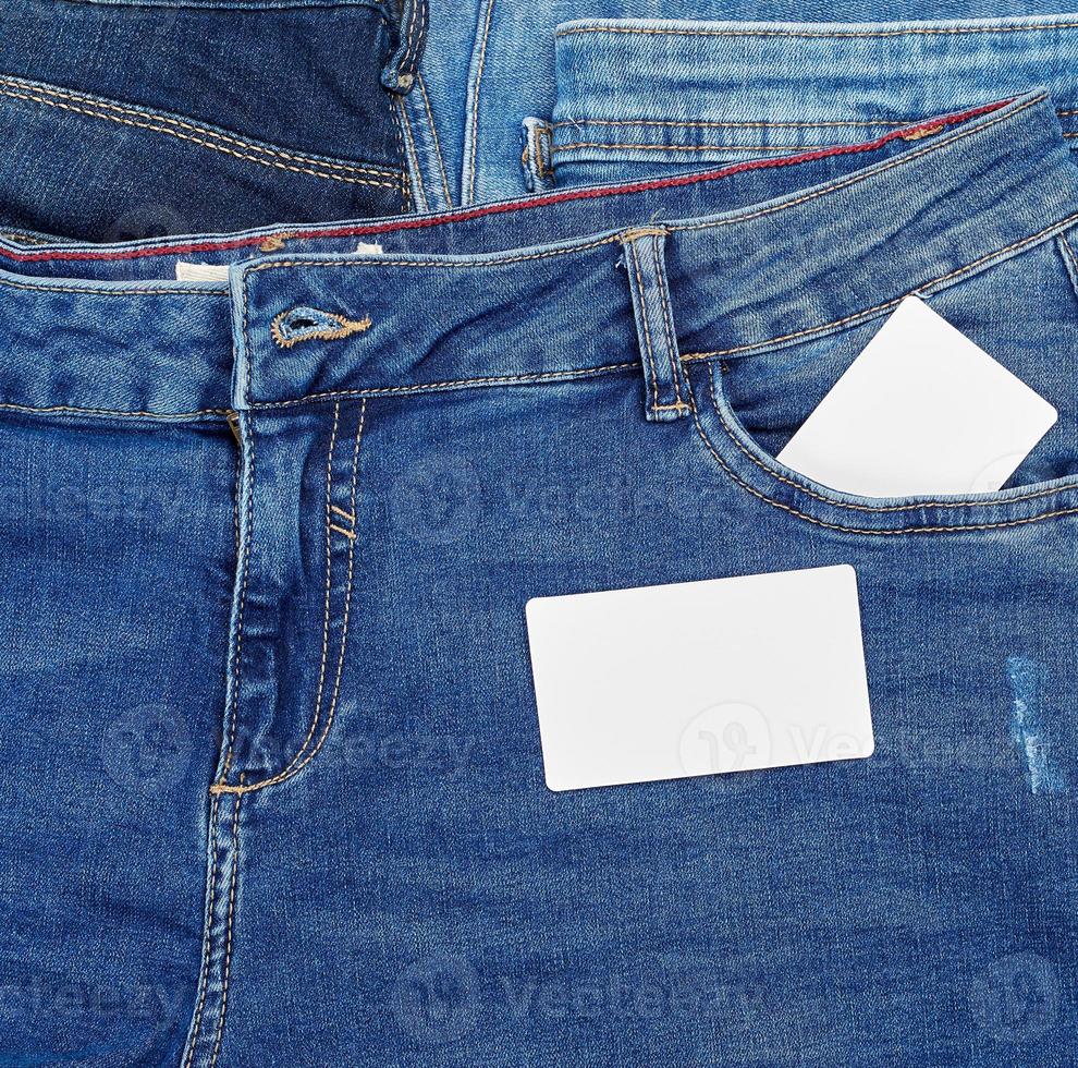 empty paper card lies on blue jeans photo