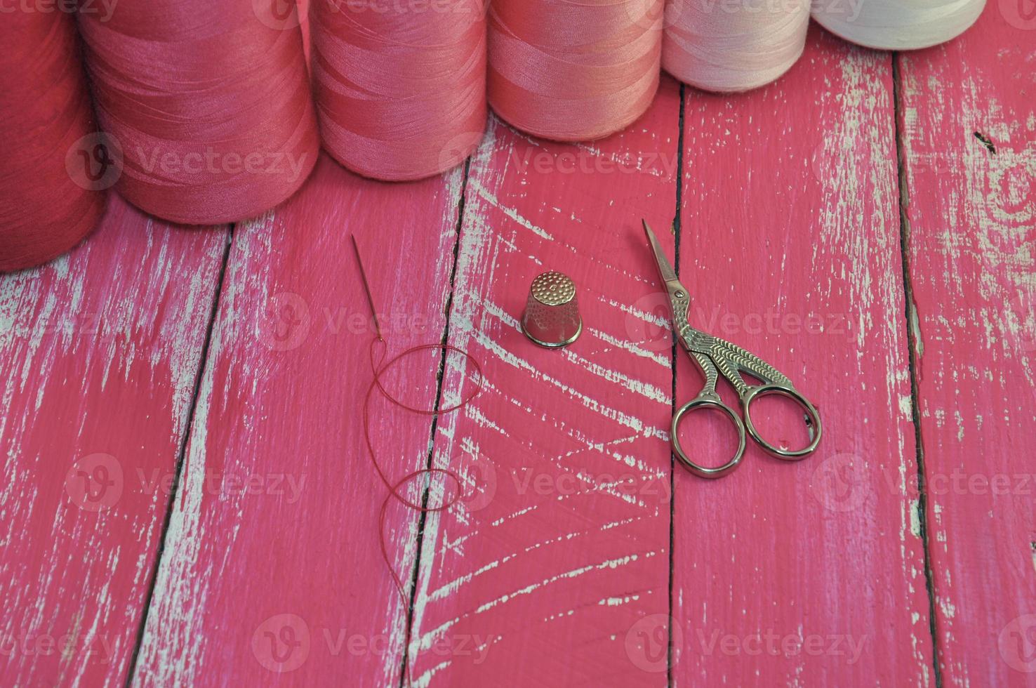 Thread, scissors and needle for sewing photo