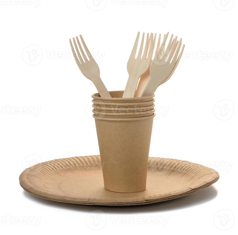 Brown paper cups, wooden fork and plates on a white background