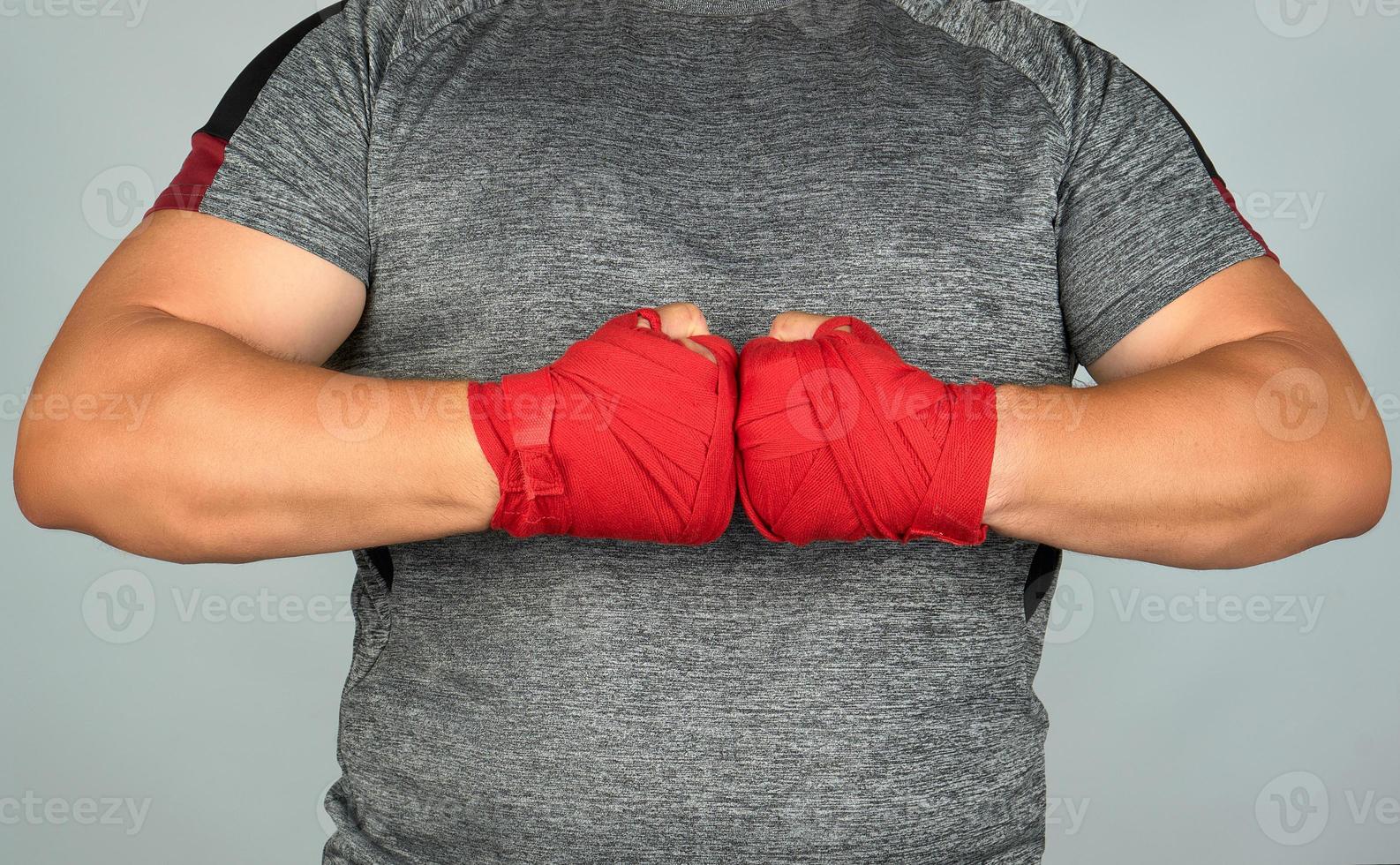 athlete in gray clothes joined his hands in front of his chest photo