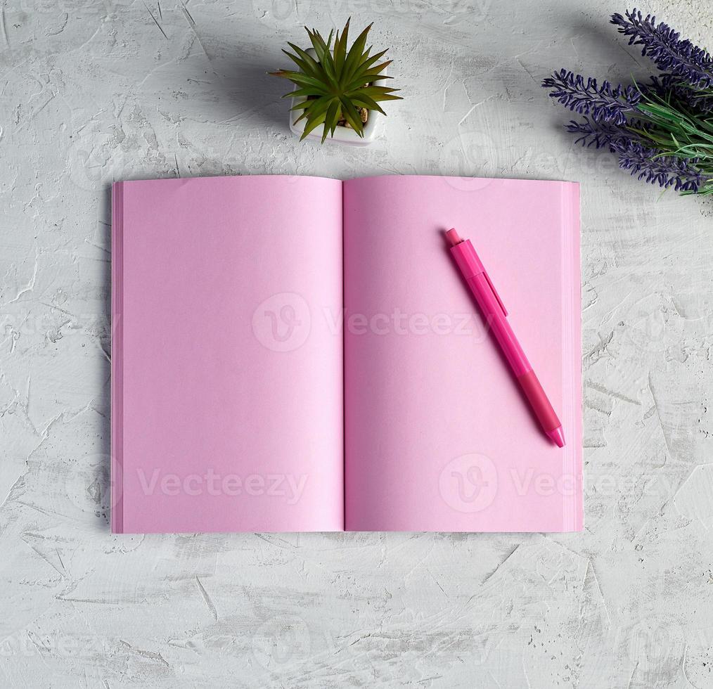 open notebook with blank pink pages, red pencil and a bouquet of lavenders photo