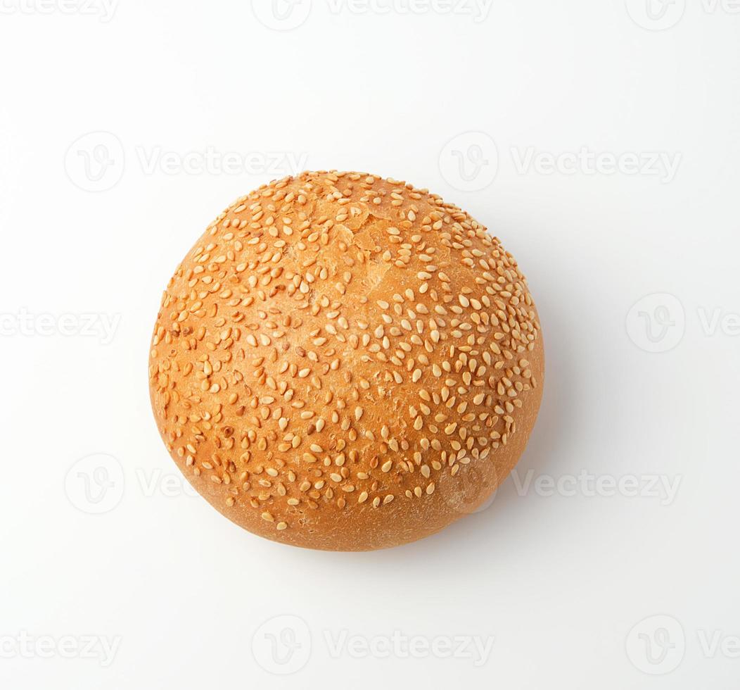 baked whole round bun with sesame seeds made from white wheat flour photo