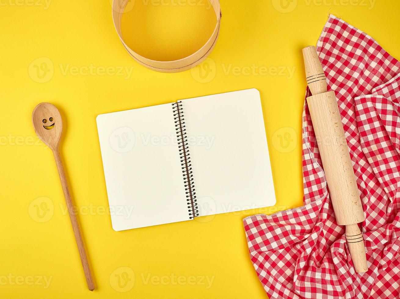 blank open notebook and wooden kitchen accessories photo