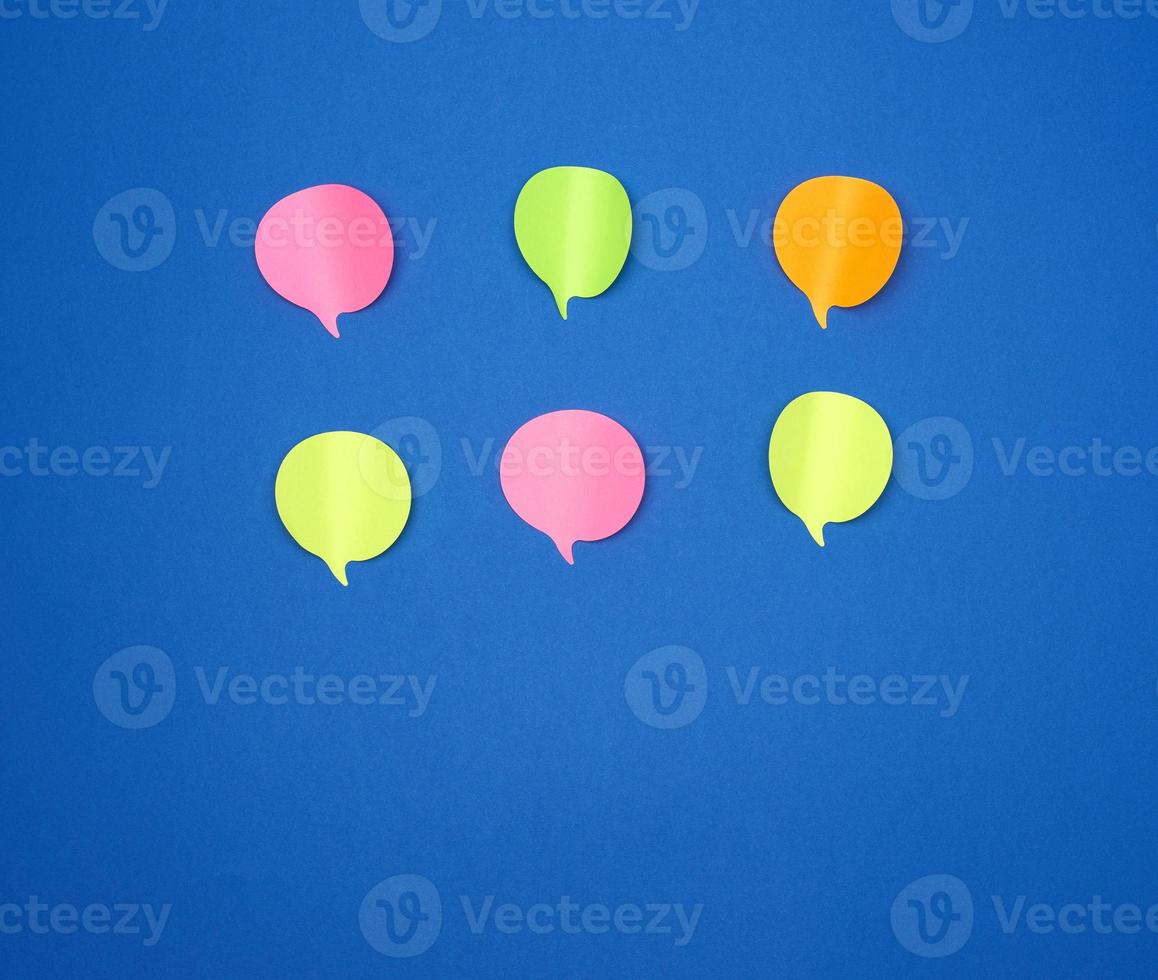 multicolored empty paper stickers in the form of clouds on a blue background photo