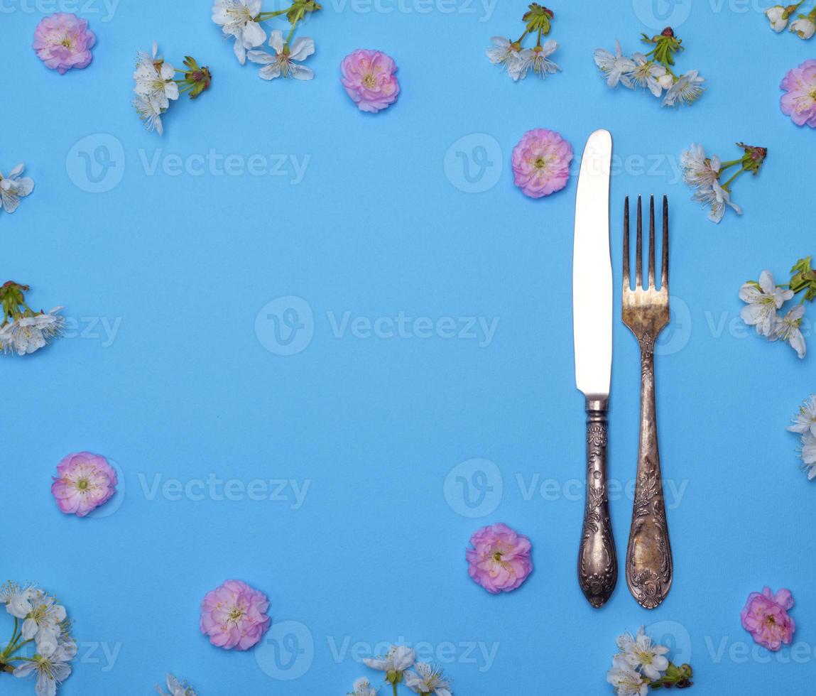 iron fork and knife on a blue background photo