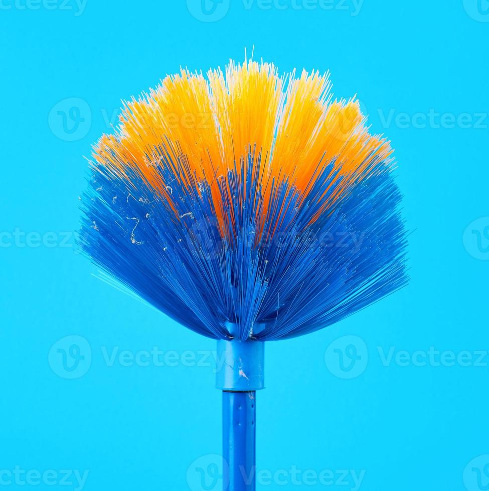 blue-yellow mop broom for collecting dust on a stick photo