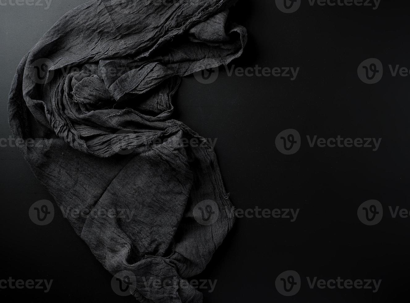 crumpled black gauze fabric on a black background photo