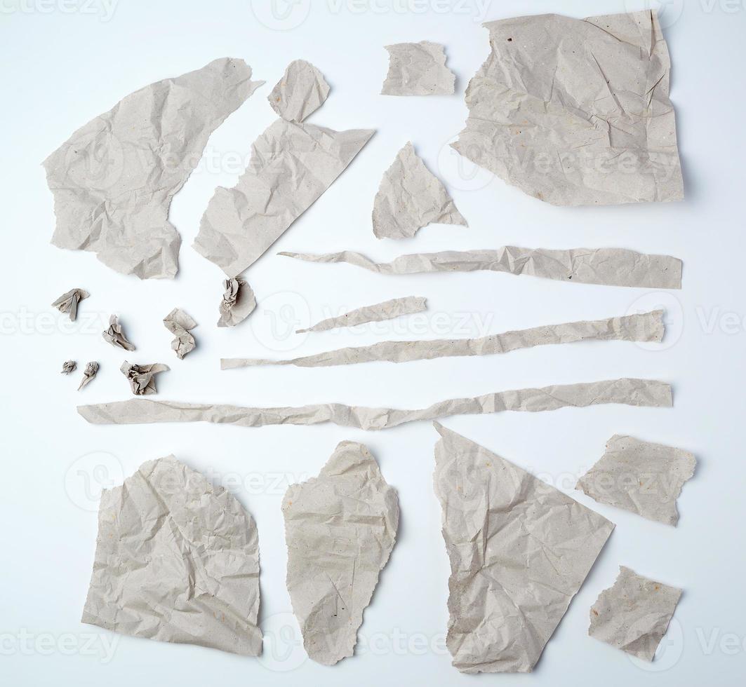 a set of various pieces of torn gray crumpled paper on a white background photo