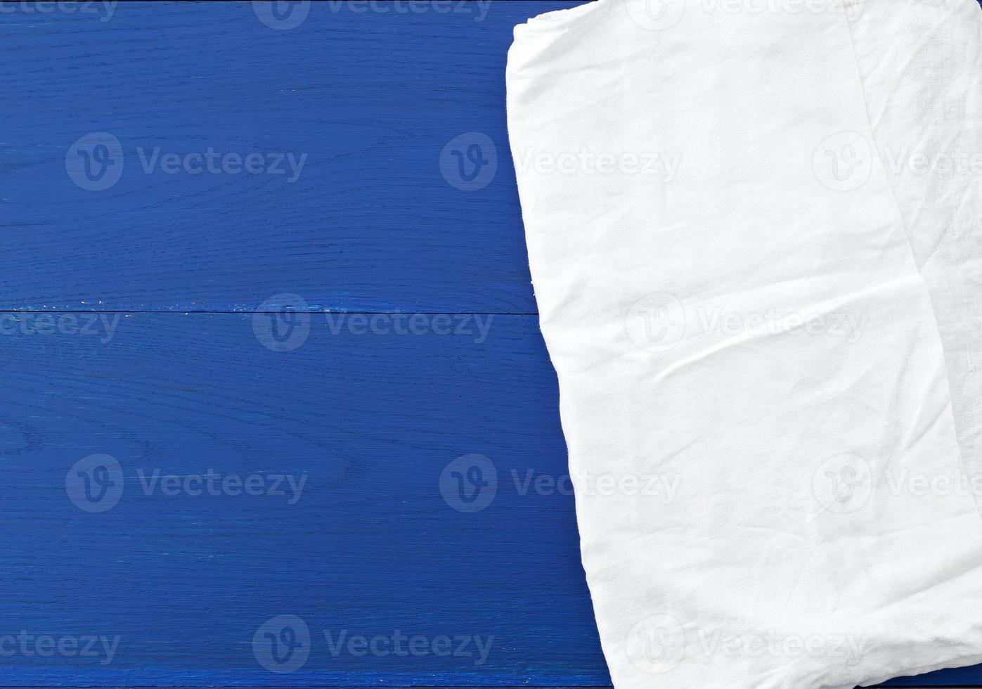 white kitchen textile towel folded on a blue wooden table from old boards photo