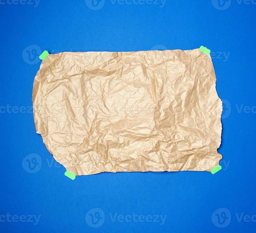 crumpled brown sheet of parchment paper glued with green paper Velcro photo