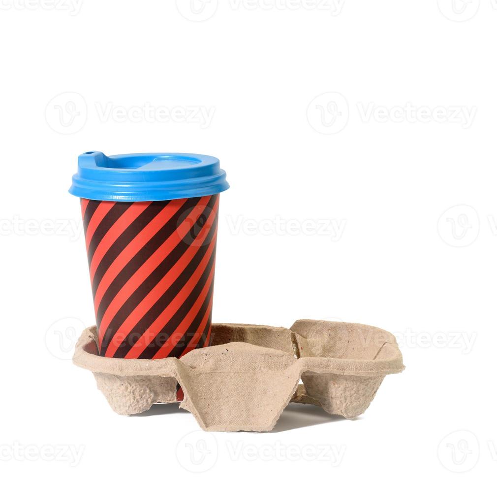 paper red striped disposable cup with plastic lid stands in paper holder on white isolated background photo