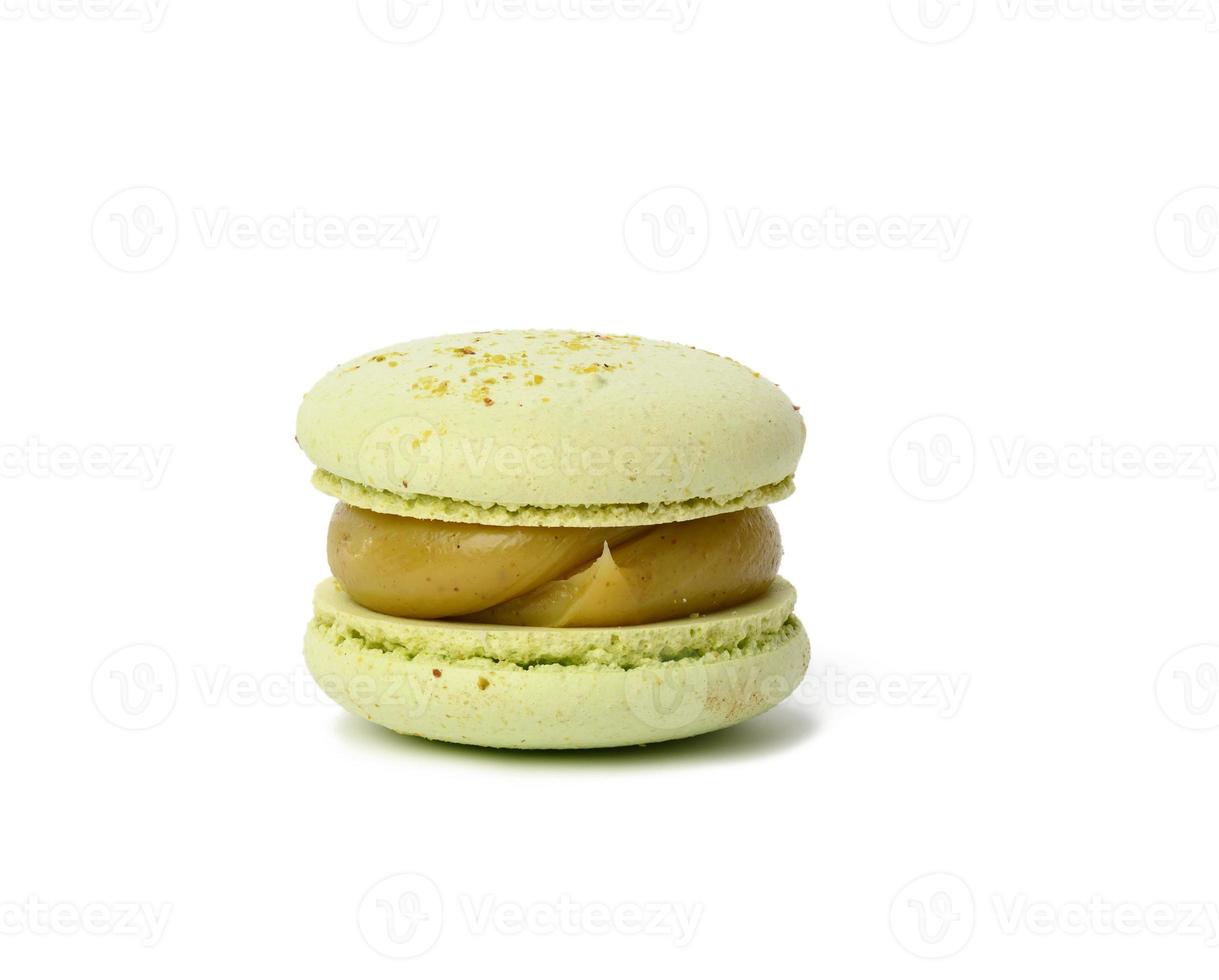 baked round pistachio macaron isolated on white background photo