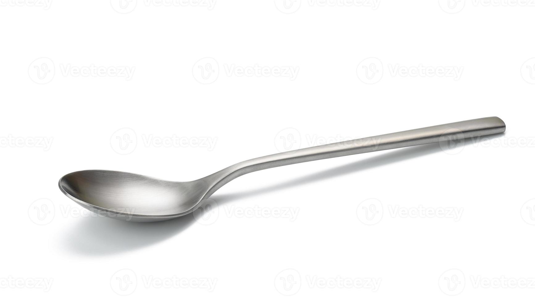 empty metal spoon on a white isolated background. Brushed steel texture photo