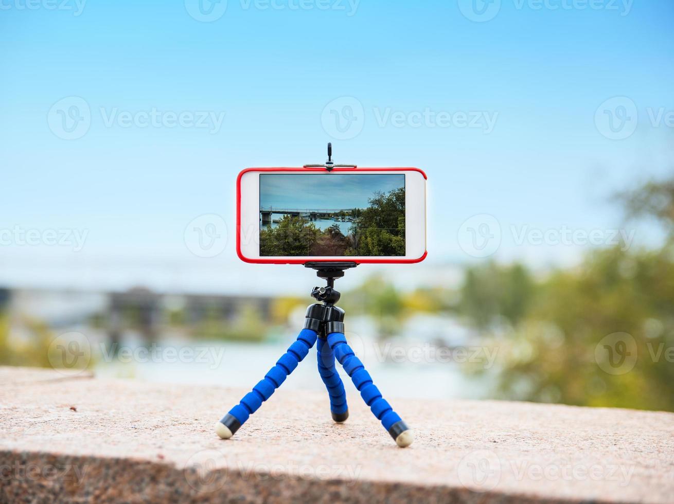 smartphone stands on a tripod photo