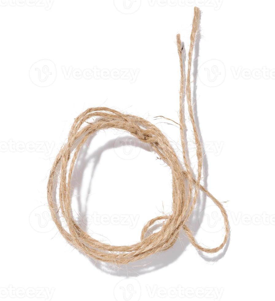 A skein of brown twine rope on a white isolated background, top view. Packing natural photo