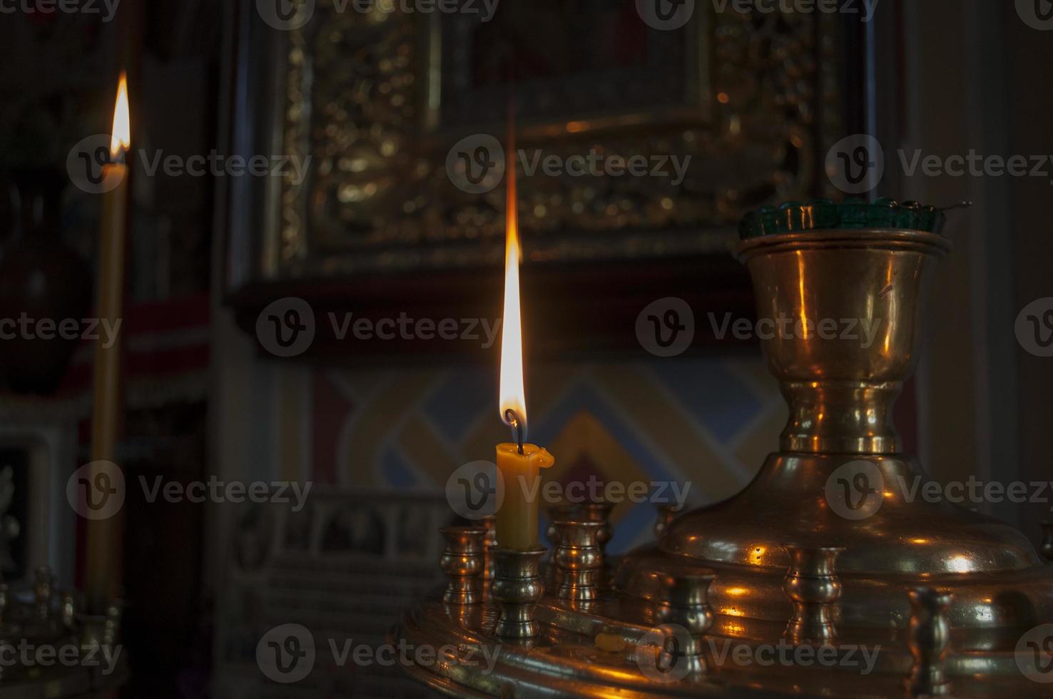 floor candle is lit on the base of the church photo